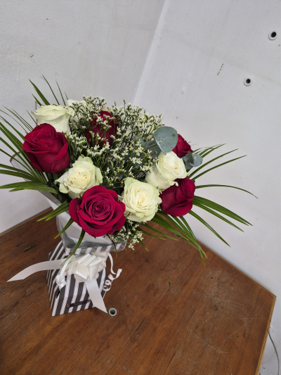 Love at First sight - An arrangement of Roses beautifully mixed with limonium and eucalyptus presented in a bouquet box . 
Boxes are lined and full with water.